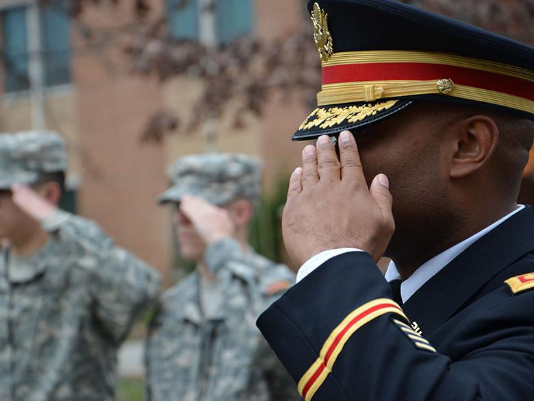 Veterans salute at Veterans Day Event